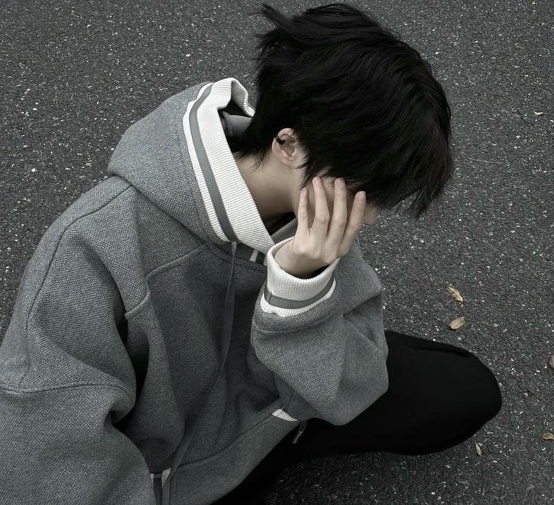 Chàng trai đưa tay che nửa gương mặt